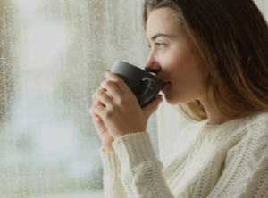 women drinking coffee by window